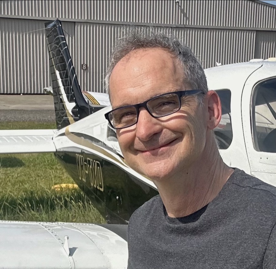 Will Pemble, founder of Goal Boss, in front of his airplane